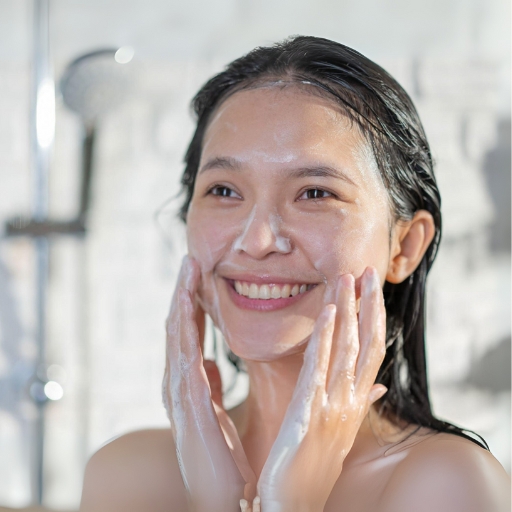 woman using goat milk body wash in shower